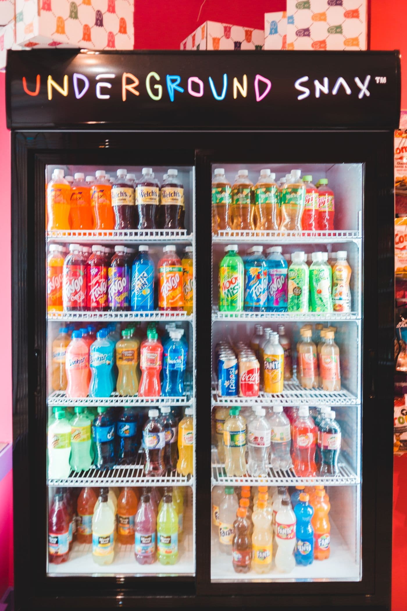 A cooler full of cold sodas, juices and waters at the corner store